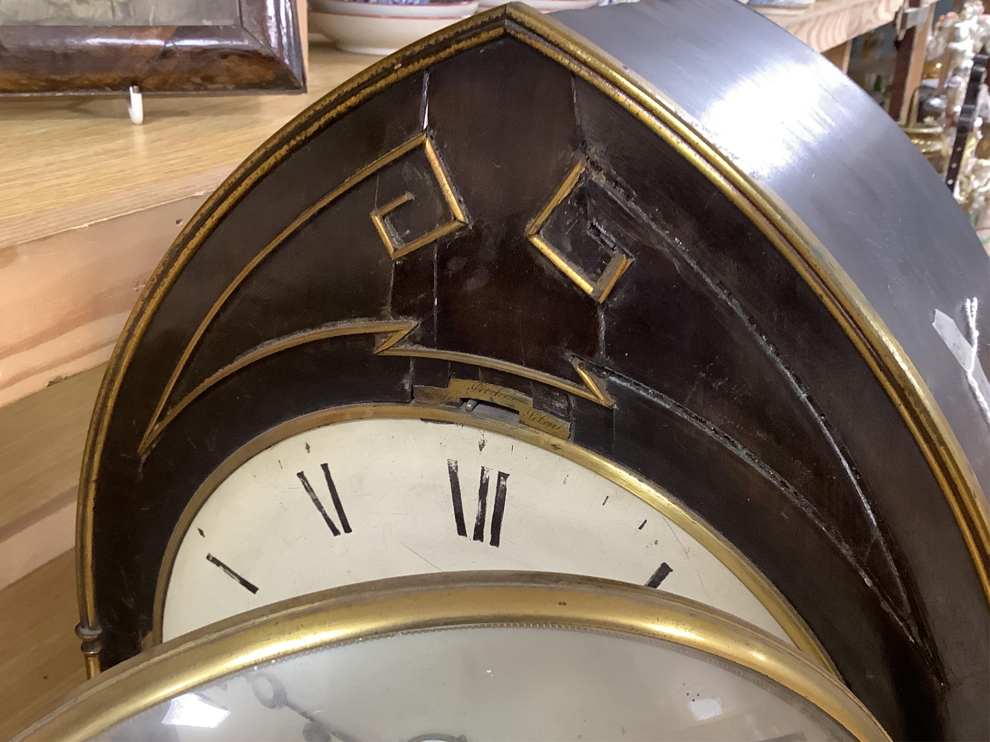A Regency ebonised and brass inlaid lancet-shape bracket clock, with key and a painted pottery strut timepiece, largest 55cm high (2)
